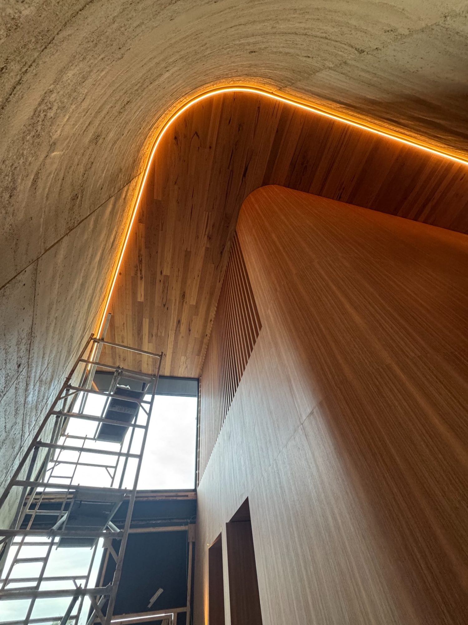 Curved rammed-earth and timber void taking shape at Cape Schanck
