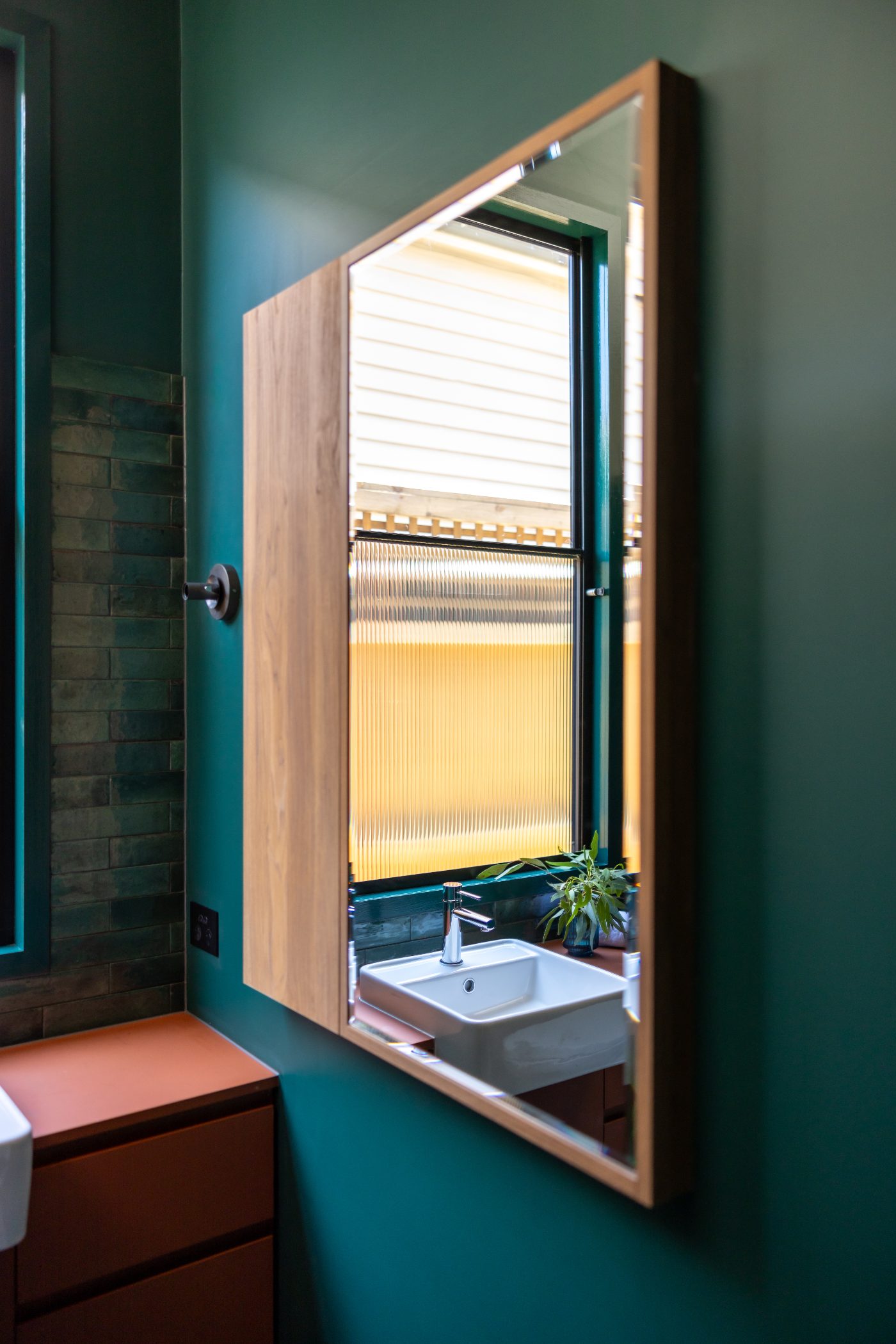 Tiled bathroom with wall-hung vanity in a Clifton Hill renovation