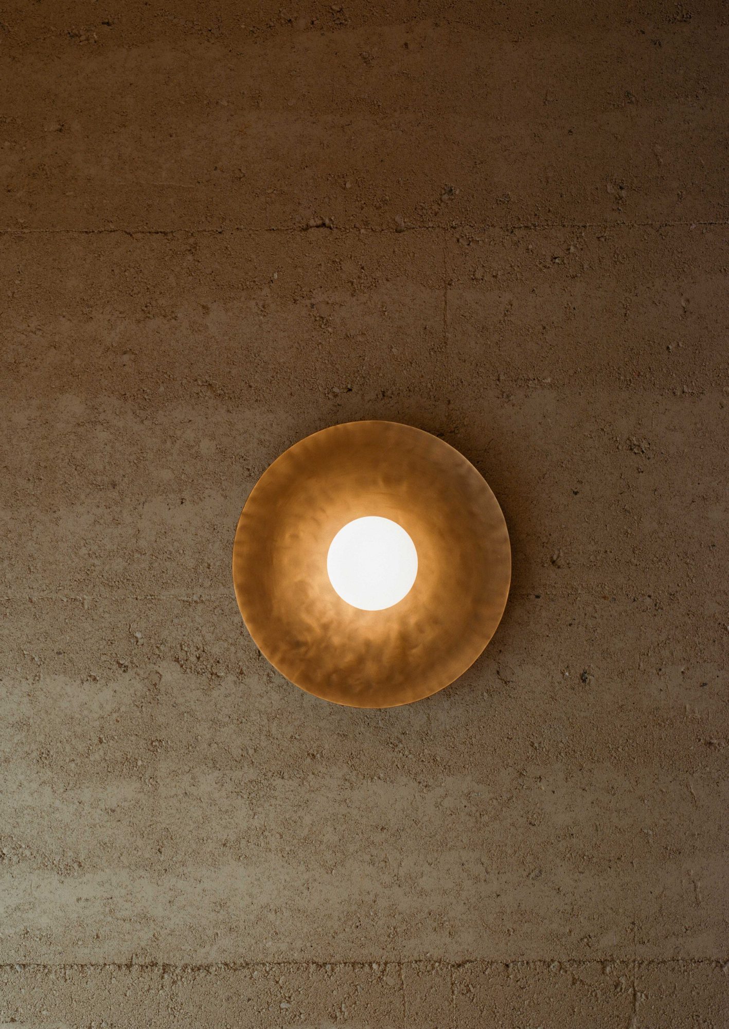 Light across a rammed-earth wall