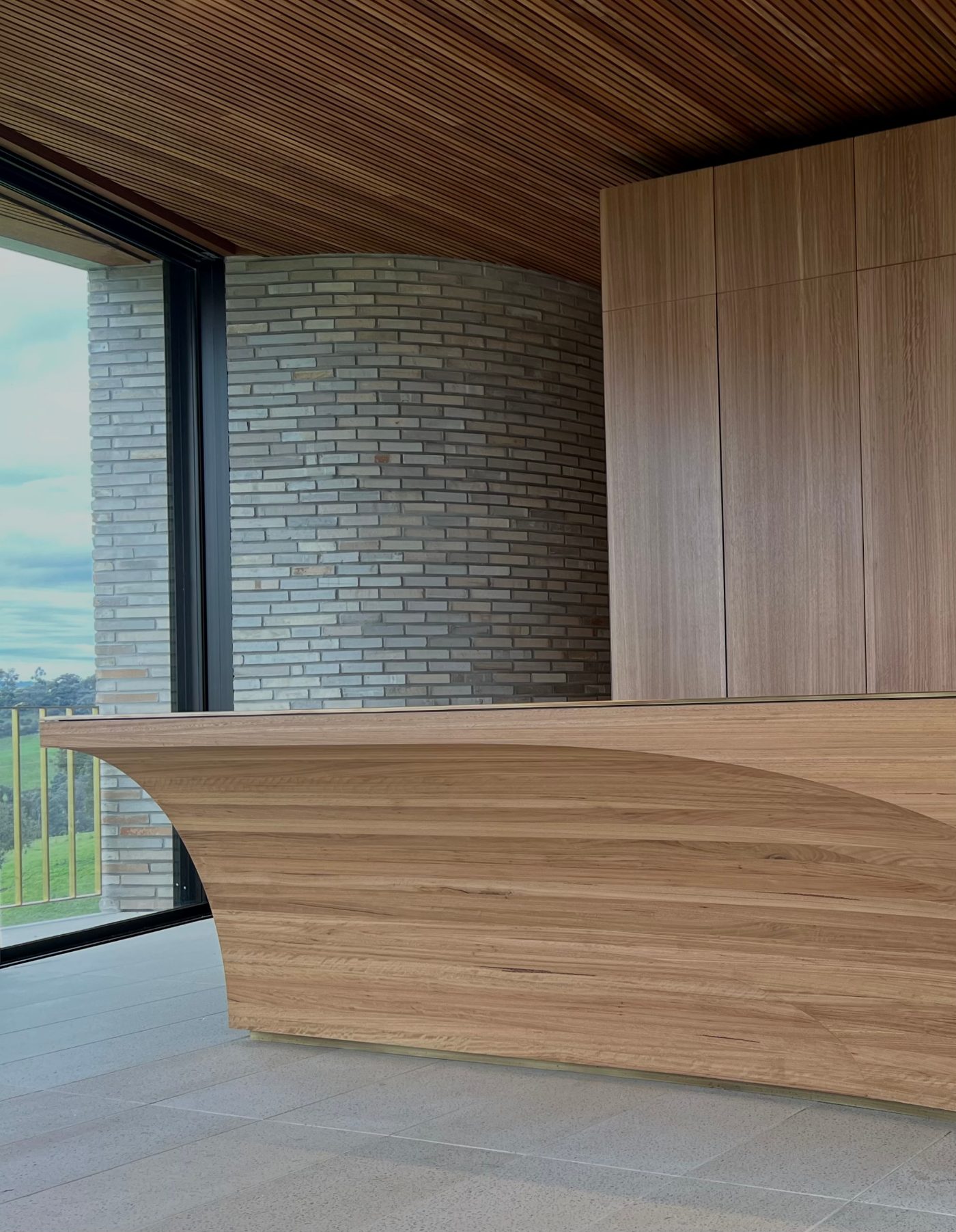 Curved timber island and brick