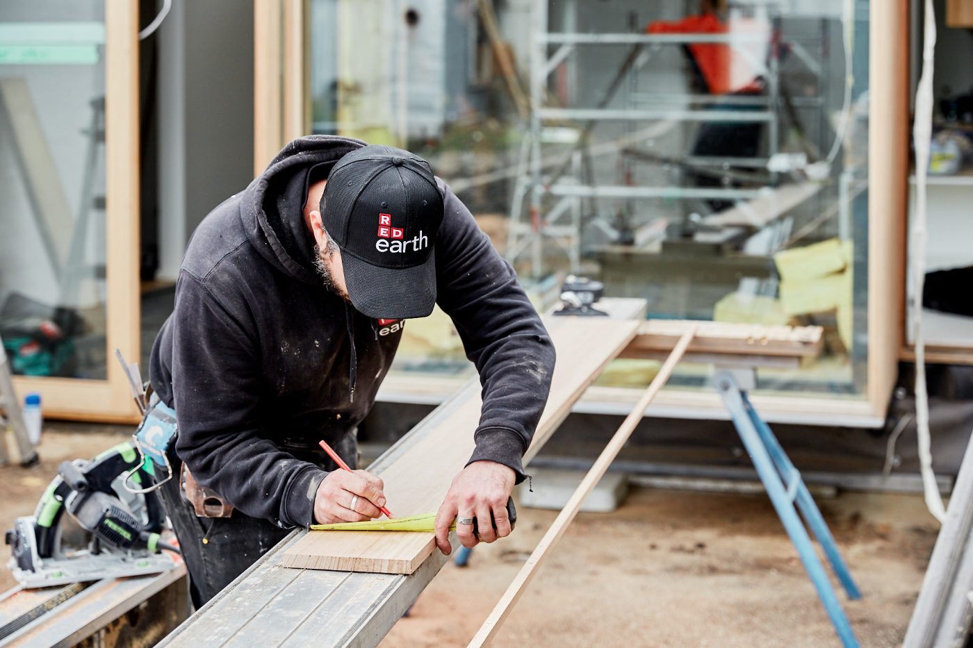 Carpenter marking out timber on site in Northcote