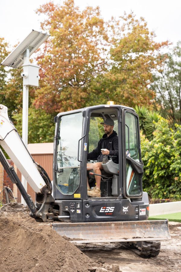 Excavator in the rear yard of an Elwood new build