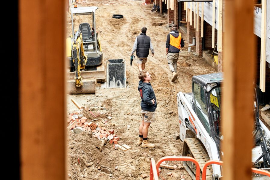 Site crew at the hoarding of a North Melbourne project